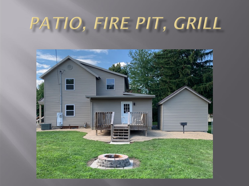 House with patio, fire pit, and grill.