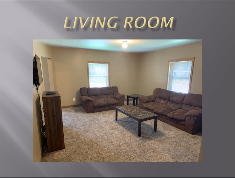 Living room with two brown couches.